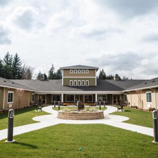 A modern building with a central courtyard and well-maintained garden.