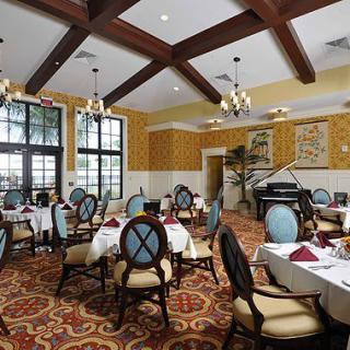 An elegant restaurant dining room with neatly arranged tables and classic decor.