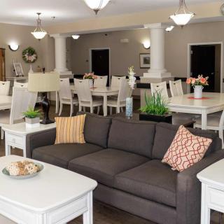 A modern living room with a comfortable sofa and an adjacent dining area.