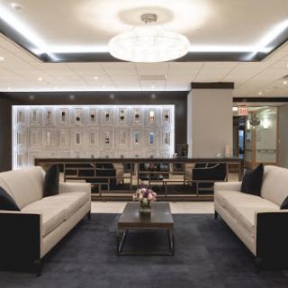 A modern hotel lobby featuring elegant seating and stylish lighting.