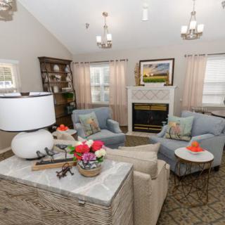 A cozy living room with stylish furniture and a warm fireplace.
