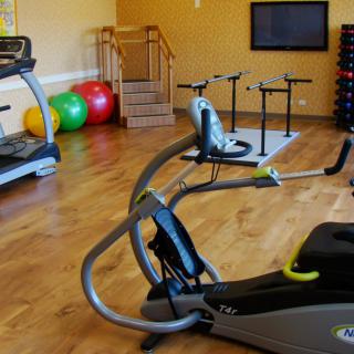 A well-equipped gym with various exercise machines and workout gear.