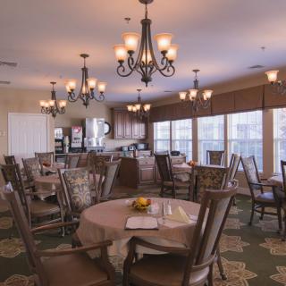 A serene dining area with elegant chandeliers and comfortable seating.