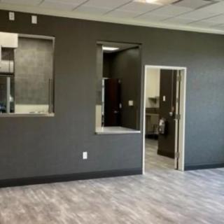 An empty office space with gray walls and modern flooring.