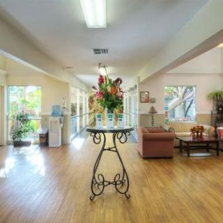A bright and spacious lobby area with a decorative table and flowers.