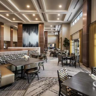 A modern dining area with elegant interior design and ample seating.
