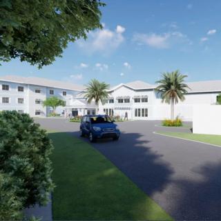 A modern building with palm trees and a car parked on the driveway under a blue sky.