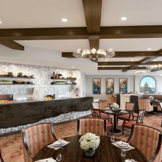 A sophisticated dining area featuring elegant chandeliers, wooden beams, and decorative touches.