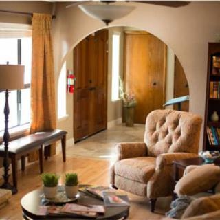 A cozy living room with comfortable armchairs and warm natural lighting.