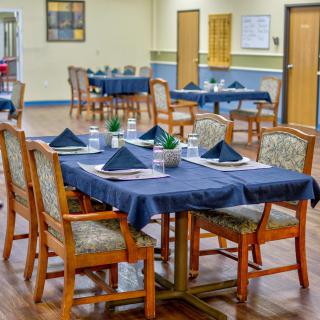 A well-arranged dining area with neatly set tables and chairs.