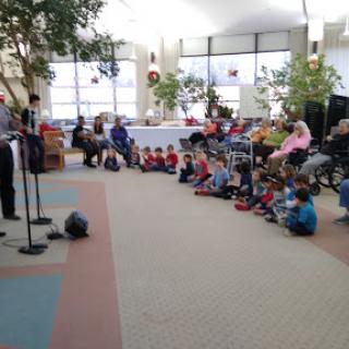 A lively performance engaging children in a cozy indoor setting.