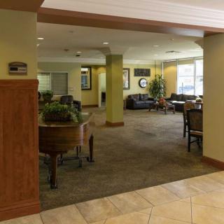 A spacious lobby area with seating, tables, and natural light.