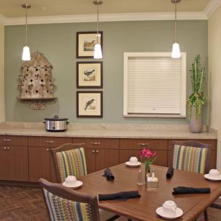 A cozy dining room with a neatly set table and stylish decor.