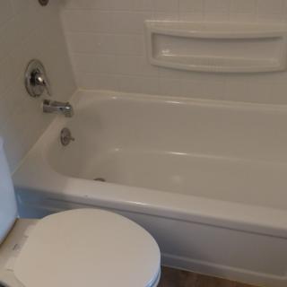 A bathroom featuring a bathtub and toilet.