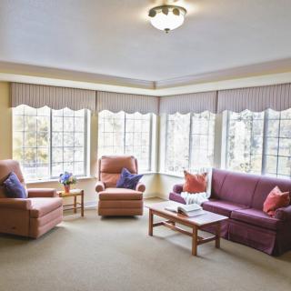 A bright and cozy living room with comfortable seating and large windows.