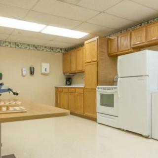 A clean and spacious kitchen with wooden cabinets and modern appliances.