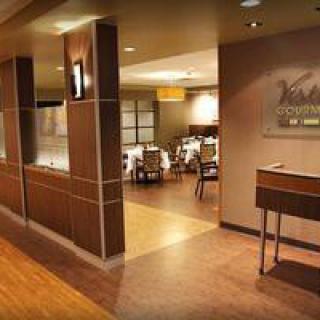 A modern restaurant interior with a welcoming entrance and elegant dining area.