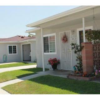 A cozy residential house with a well-maintained front yard and porch.