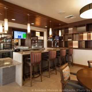 A modern bar area with comfortable seating and stylish lighting.
