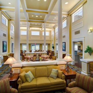 A luxurious and spacious lobby area featuring elegant furniture and grand pillars.