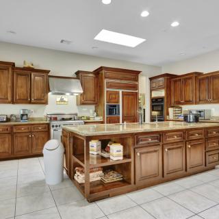 A spacious modern kitchen with wooden cabinets and a central island.