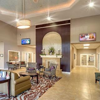 A modern and inviting lobby space featuring stylish furniture and warm lighting.