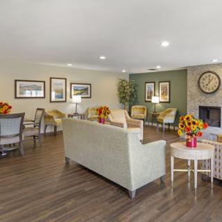 A cozy living room with modern furniture and floral decor.