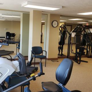 A well-equipped gym with various exercise machines and fitness equipment.