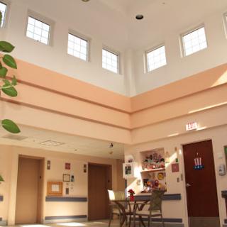 A spacious and inviting hospital lobby featuring abundant natural light and comfortable seating.