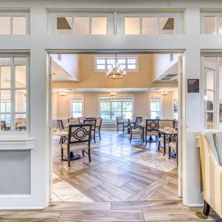 A bright and spacious dining area with elegant furniture and ample natural light.