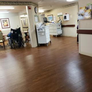 A view of the interior of a healthcare facility, featuring a wheelchair and medical equipment.
