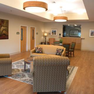 A cozy lounge area featuring comfortable seating, warm lighting, and modern decor.