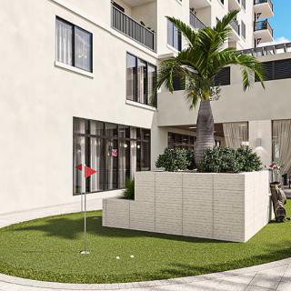 A modern courtyard featuring a palm tree and a small putting green area.