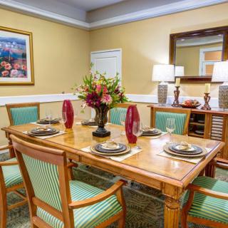 A beautifully set dining room with elegant table settings and tasteful decor.