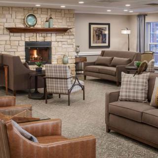 A cozy living room with comfortable seating and a fireplace.