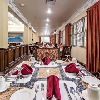 An elegantly set dining table in a spacious restaurant interior.