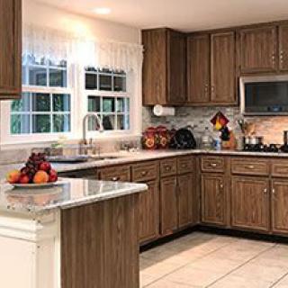 A cozy kitchen with wood cabinets and modern appliances.