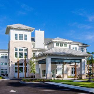 A modern residential building with a blue sky backdrop.