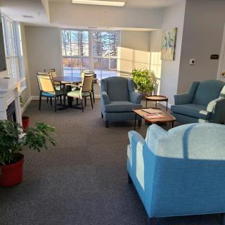 A cozy living room with ample seating and natural light streaming through the windows.