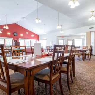 A spacious dining room with wooden tables and chairs.