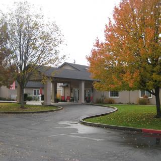 Entrance to a building surrounded by autumn foliage.