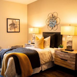 A cozy bedroom with warm lighting and modern decor.