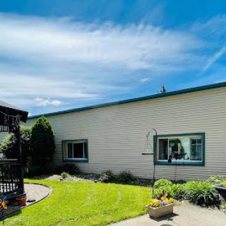 A peaceful residential exterior featuring a well-maintained garden and clear blue skies.