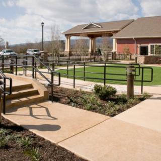 A scenic view of a building with a well-maintained pathway and landscaped greenery.