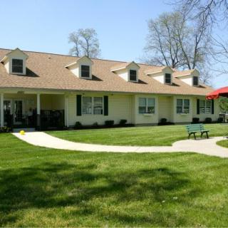 A suburban house with a well-maintained lawn and a pathway leading to the entrance.