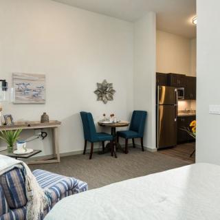 A cozy apartment interior with a dining area and kitchen.
