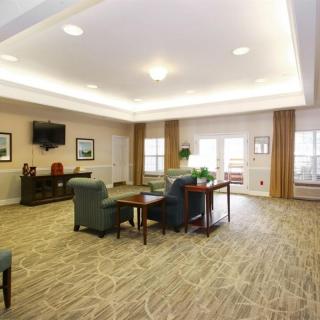 A spacious lounge area with comfortable seating and a television.