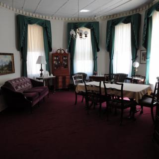 A vintage dining room with antique furniture and elegant decor.