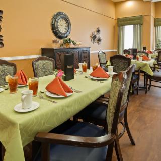 A well-appointed dining room with neatly set tables and decorative elements.