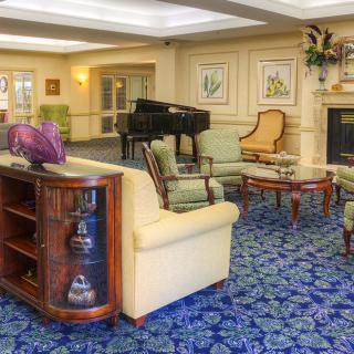 A cozy living room with elegant furniture and a grand piano.